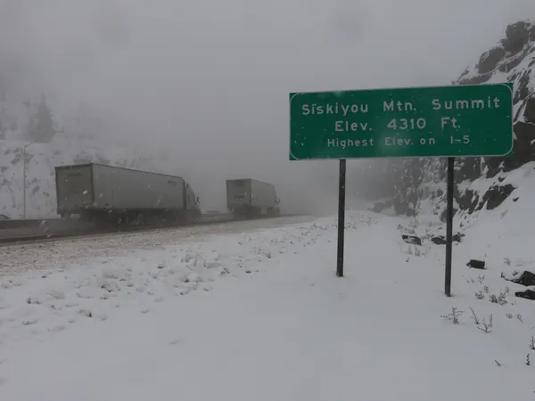 Trucks in snow at Siskiyou Summit on Interstate 5, the highest point on I-5